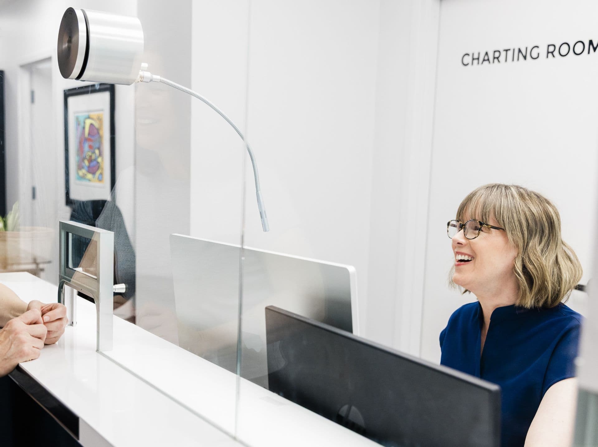 SkinCan clinic background with customer checking in at counter